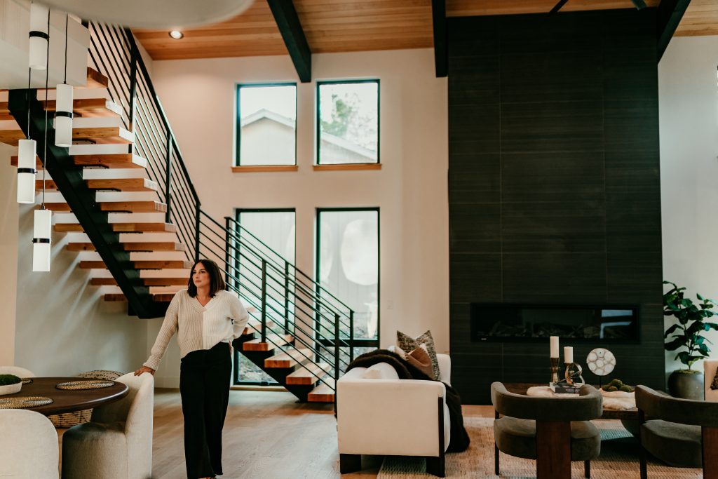 Lacie Pech, Bend Oregon real estate broker, standing in the great room of a modern Central Oregon home